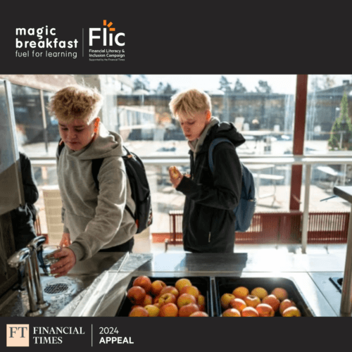 Two secondary school students help themselves to drinks and fruit from a school breakfast bar